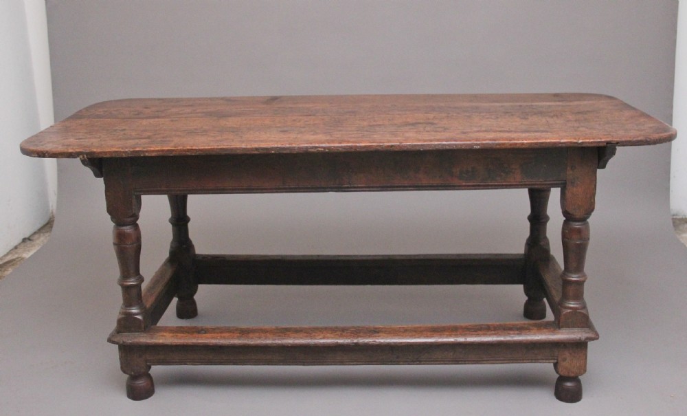 A 17th-century oak refectory table featuring a plank top, turned legs, and a perimeter box stretcher base. View III