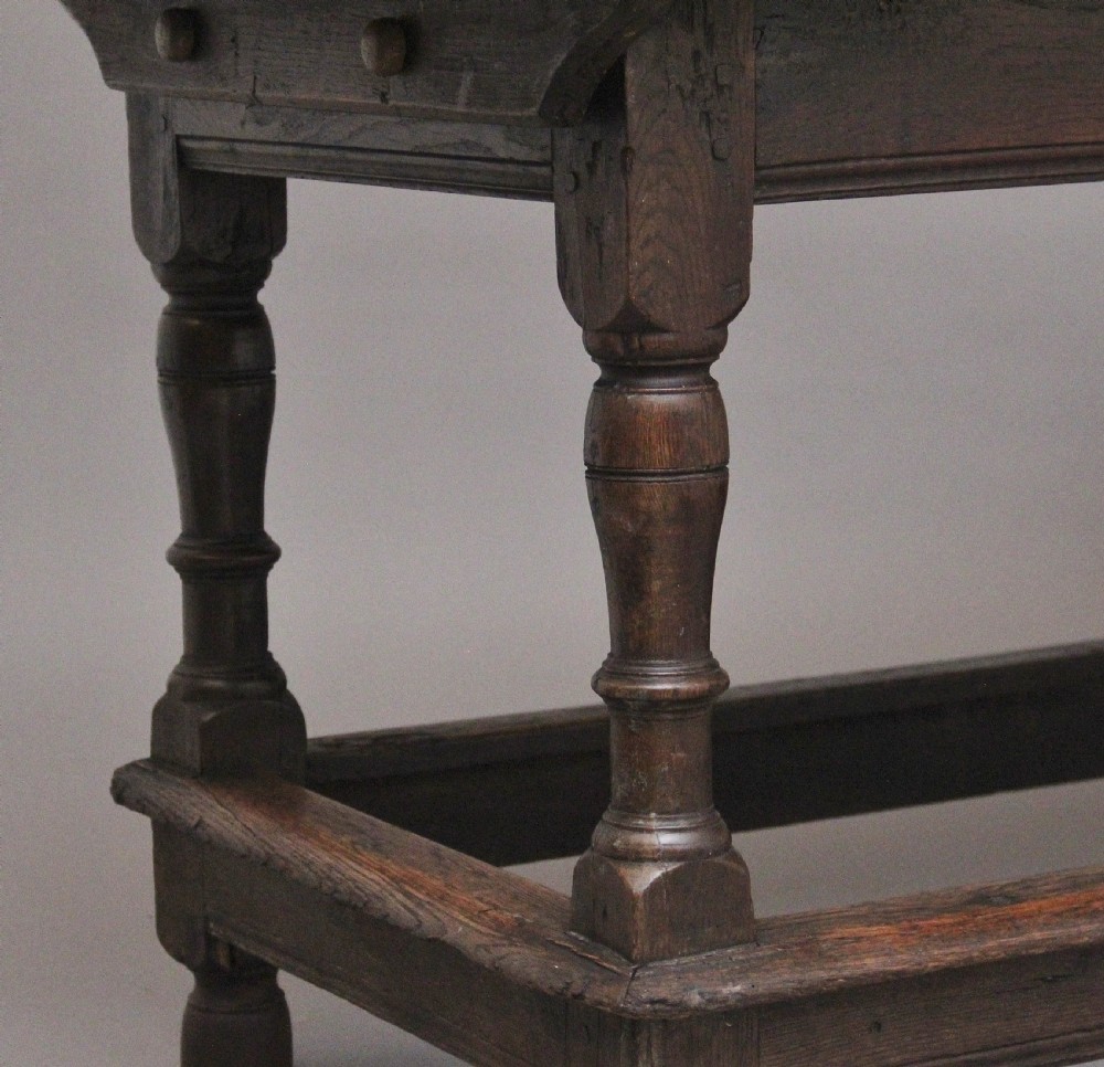 A 17th-century oak refectory table featuring a plank top, turned legs, and a perimeter box stretcher base. View VI