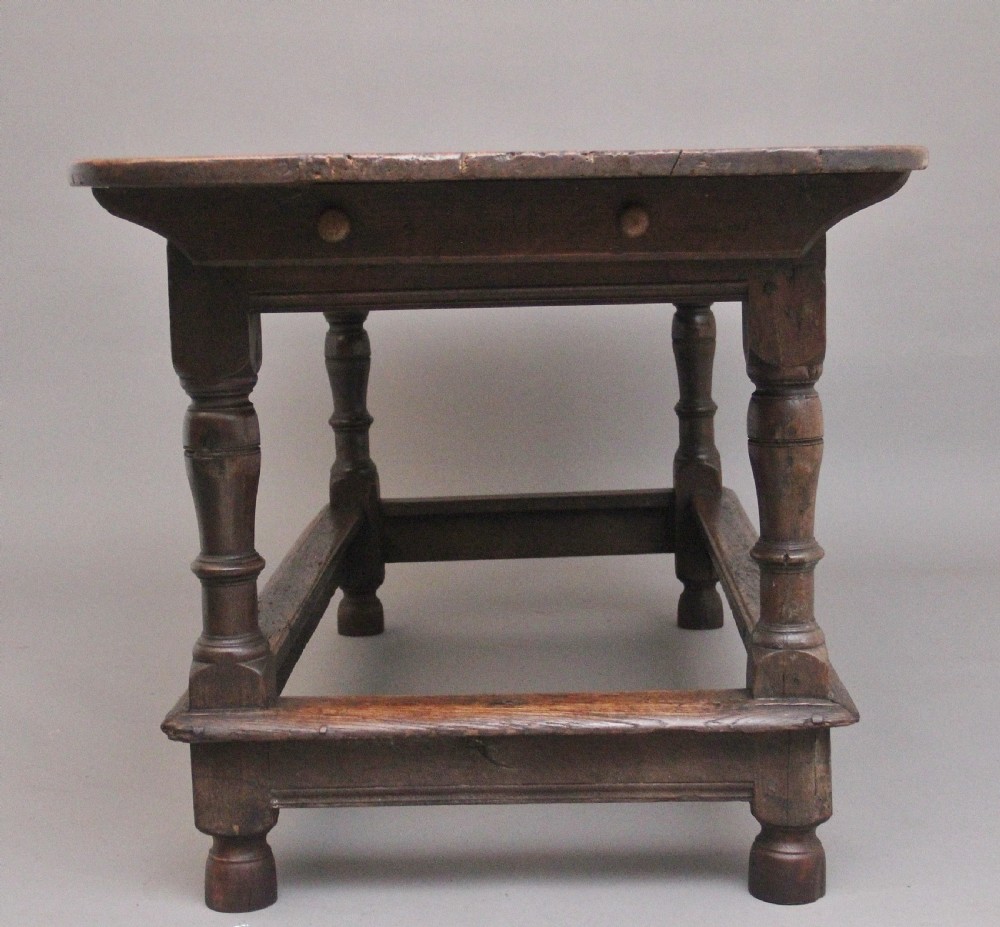A 17th-century oak refectory table featuring a plank top, turned legs, and a perimeter box stretcher base. View VII