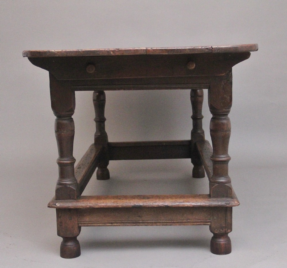 A 17th-century oak refectory table featuring a plank top, turned legs, and a perimeter box stretcher base. View IX