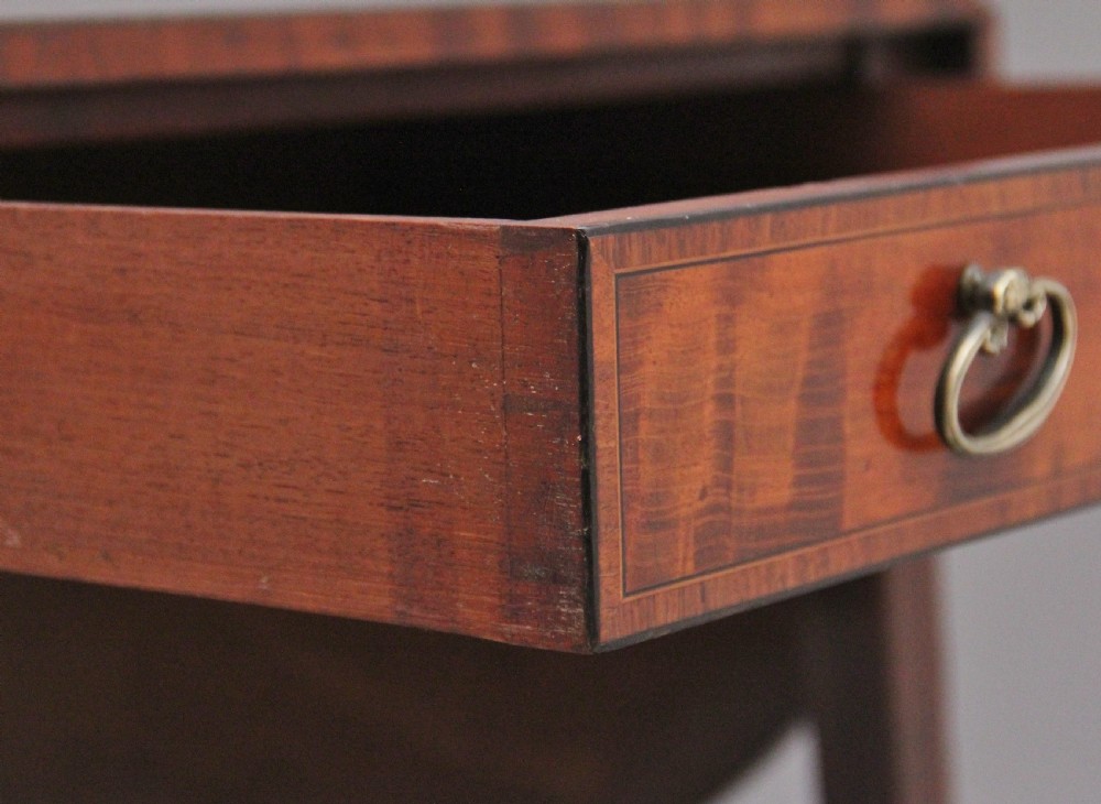 An early 19th-century inlaid mahogany Pembroke table with rounded drop leaves, a single frieze drawer, tapered legs, and brass castors. View XI