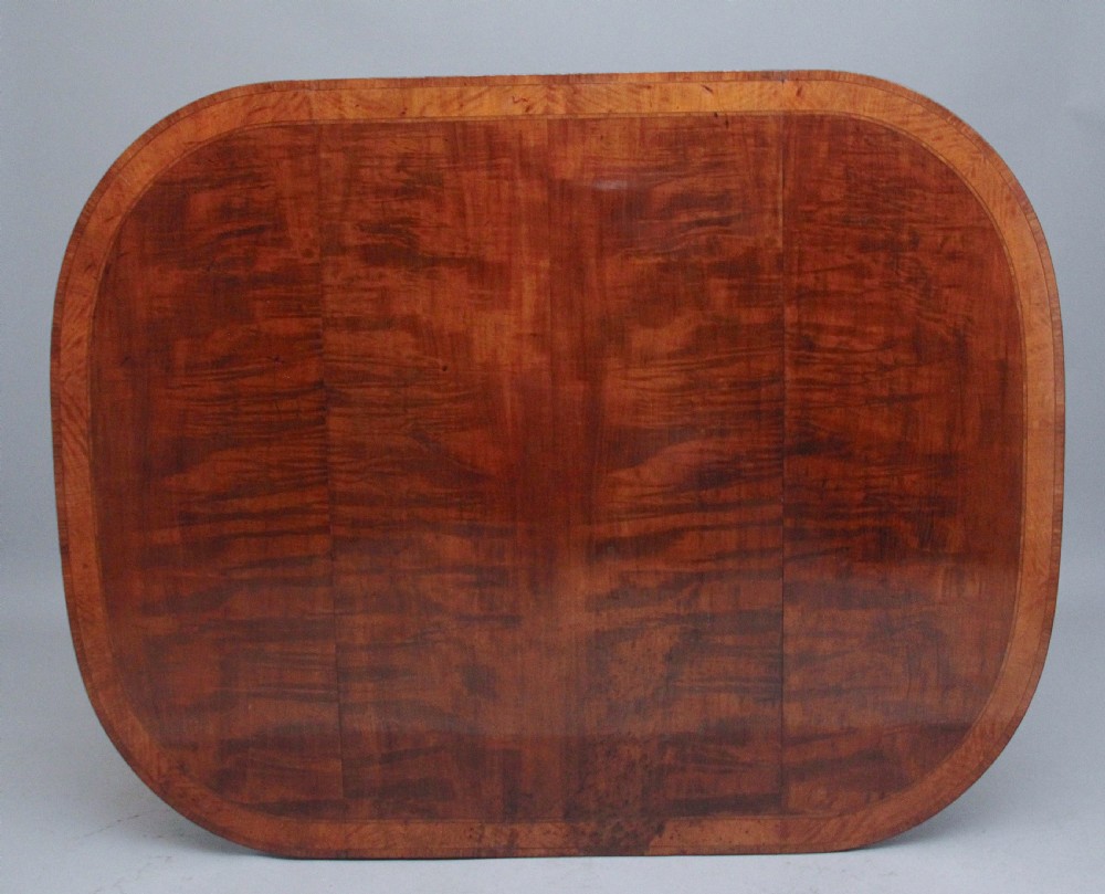 An early 19th-century inlaid mahogany Pembroke table with rounded drop leaves, a single frieze drawer, tapered legs, and brass castors. View XII
