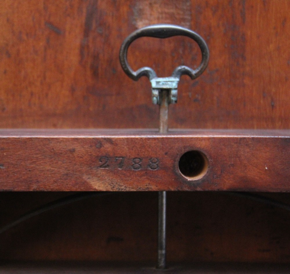 A 19th-century Victorian burr walnut centre table with a shaped, highly figured tilt-top top, raised on a carved pedestal with four cabriole legs on brass castors. View XII