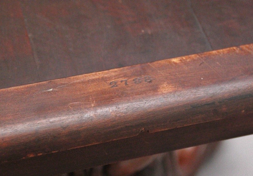 A 19th-century Victorian burr walnut centre table with a shaped, highly figured tilt-top top, raised on a carved pedestal with four cabriole legs on brass castors. View XIII