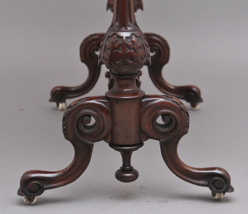 A Victorian burr walnut fold-over card table featuring a serpentine top, carved turned supports, and a stretcher base on castors. View XII