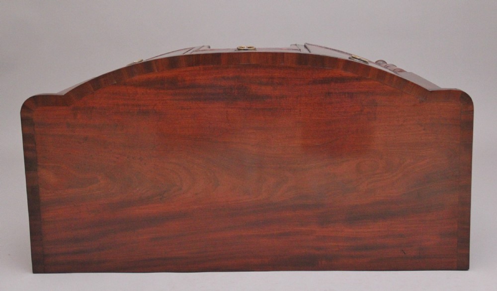 An early 19th-century bowfront mahogany sideboard with turned legs, brass ring drop handles, and central arch drawer. View X