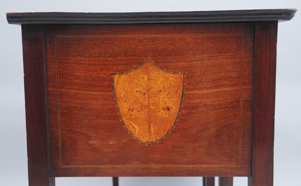 A nineteenth-century mahogany sideboard featuring burr elm veneer panels, two side cupboards, a central drawer above an arched apron, and four tapered square legs with brass ring handles. View XII