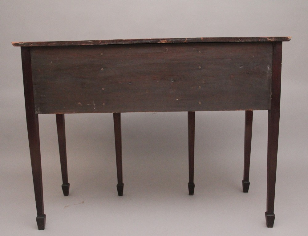 A nineteenth-century mahogany sideboard featuring burr elm veneer panels, two side cupboards, a central drawer above an arched apron, and four tapered square legs with brass ring handles. View XIII
