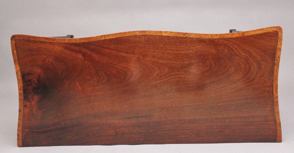 A nineteenth-century mahogany sideboard featuring burr elm veneer panels, two side cupboards, a central drawer above an arched apron, and four tapered square legs with brass ring handles. View XV