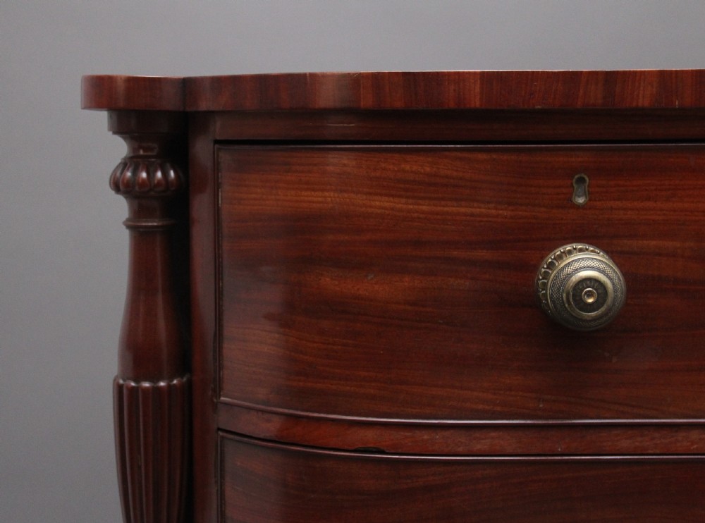 A 19th-century mahogany bowfront chest of drawers featuring two short over three long drawers flanked by reeded side columns. View II
