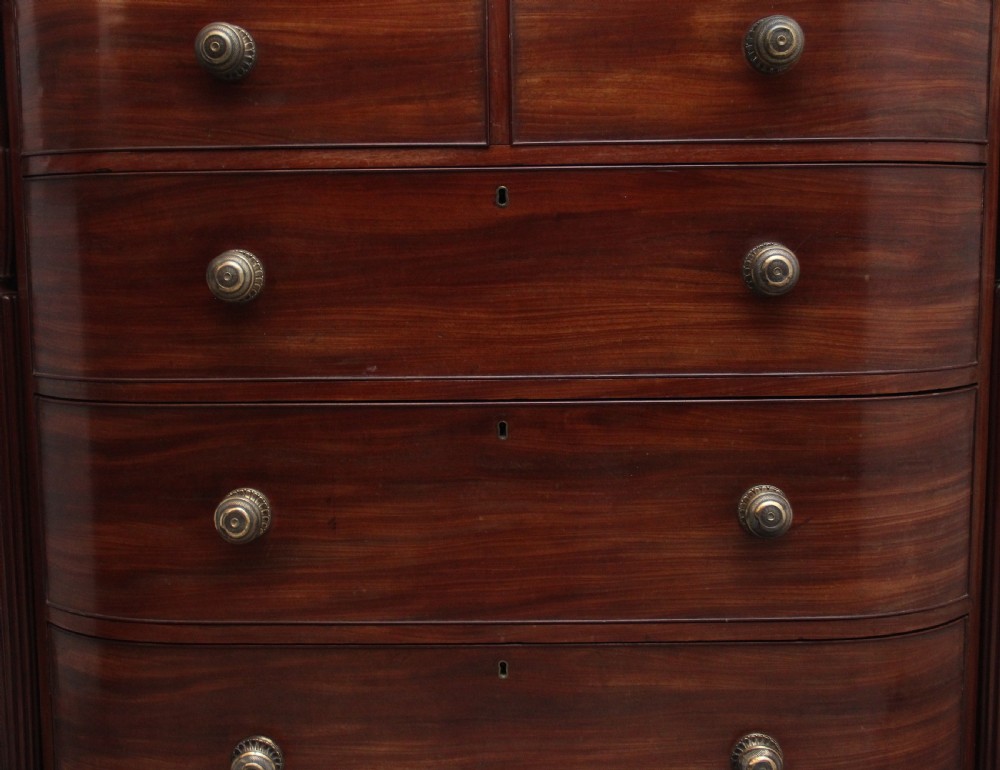A 19th-century mahogany bowfront chest of drawers featuring two short over three long drawers flanked by reeded side columns. View V