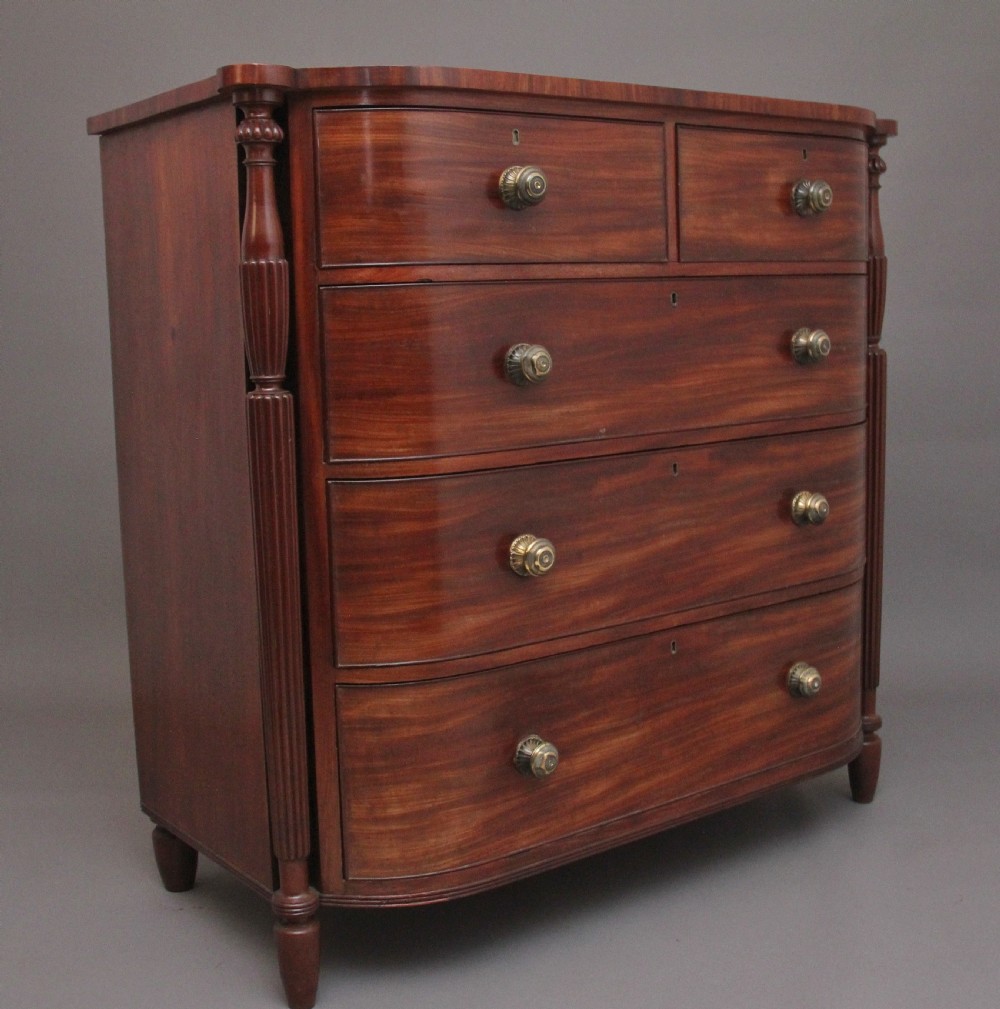 A 19th-century mahogany bowfront chest of drawers featuring two short over three long drawers flanked by reeded side columns. View VIII