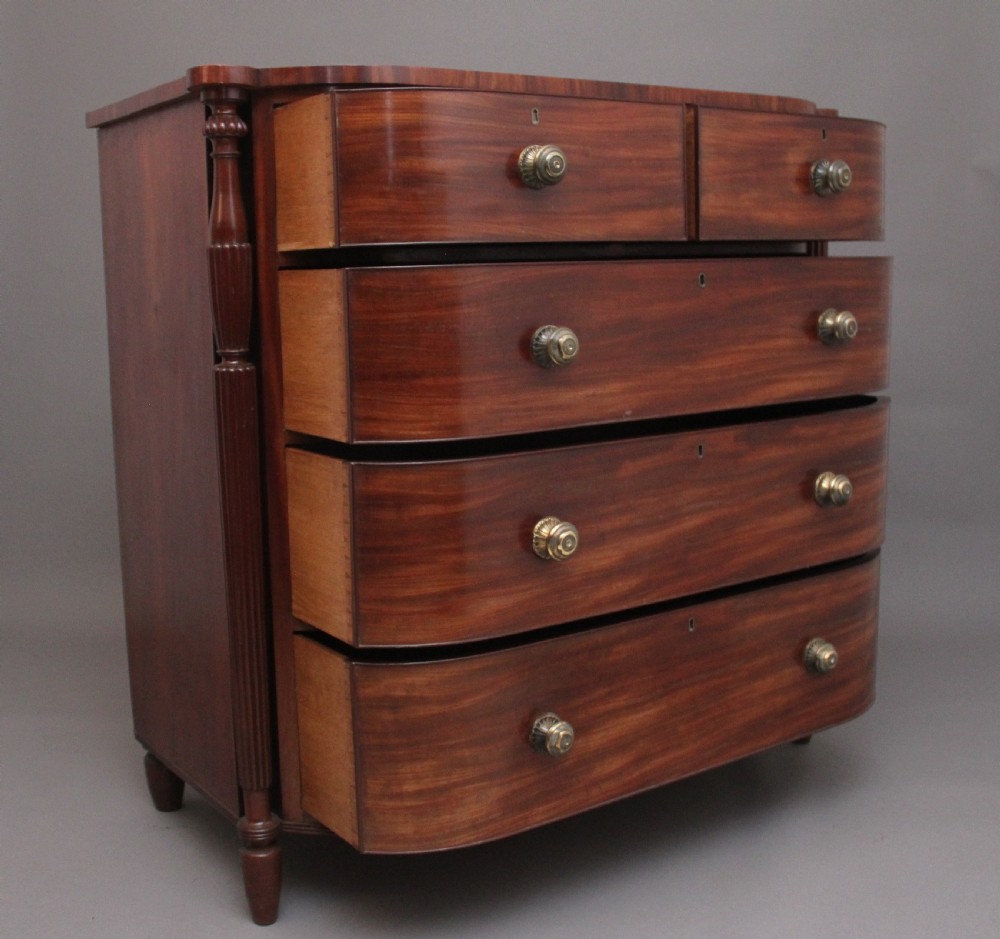 A 19th-century mahogany bowfront chest of drawers featuring two short over three long drawers flanked by reeded side columns. View IX