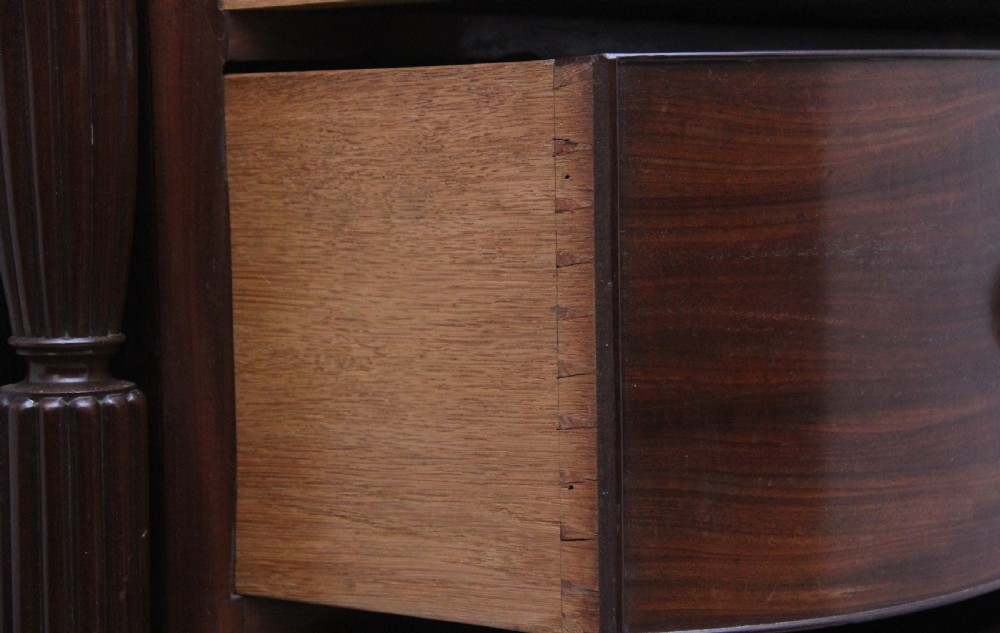 A 19th-century mahogany bowfront chest of drawers featuring two short over three long drawers flanked by reeded side columns. View X