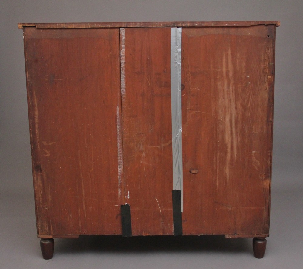 A 19th-century mahogany bowfront chest of drawers featuring two short over three long drawers flanked by reeded side columns. View XII