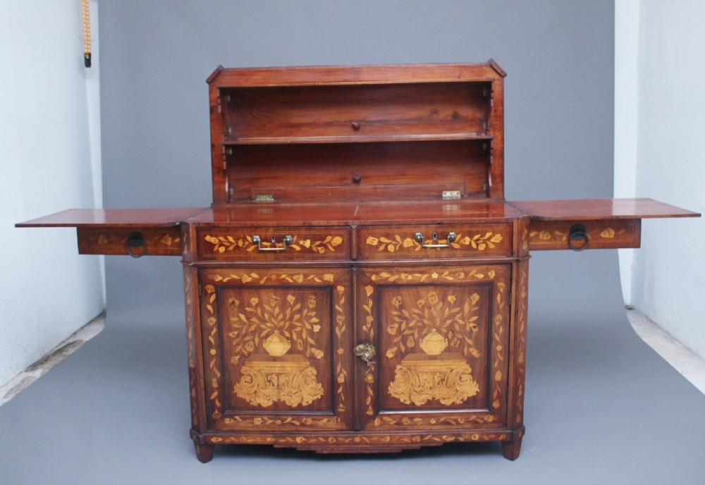 An early 19th-century Dutch travelling cabinet featuring floral fruitwood marquetry inlays, two upper drawers, two panelled doors, and side drop handles. View III