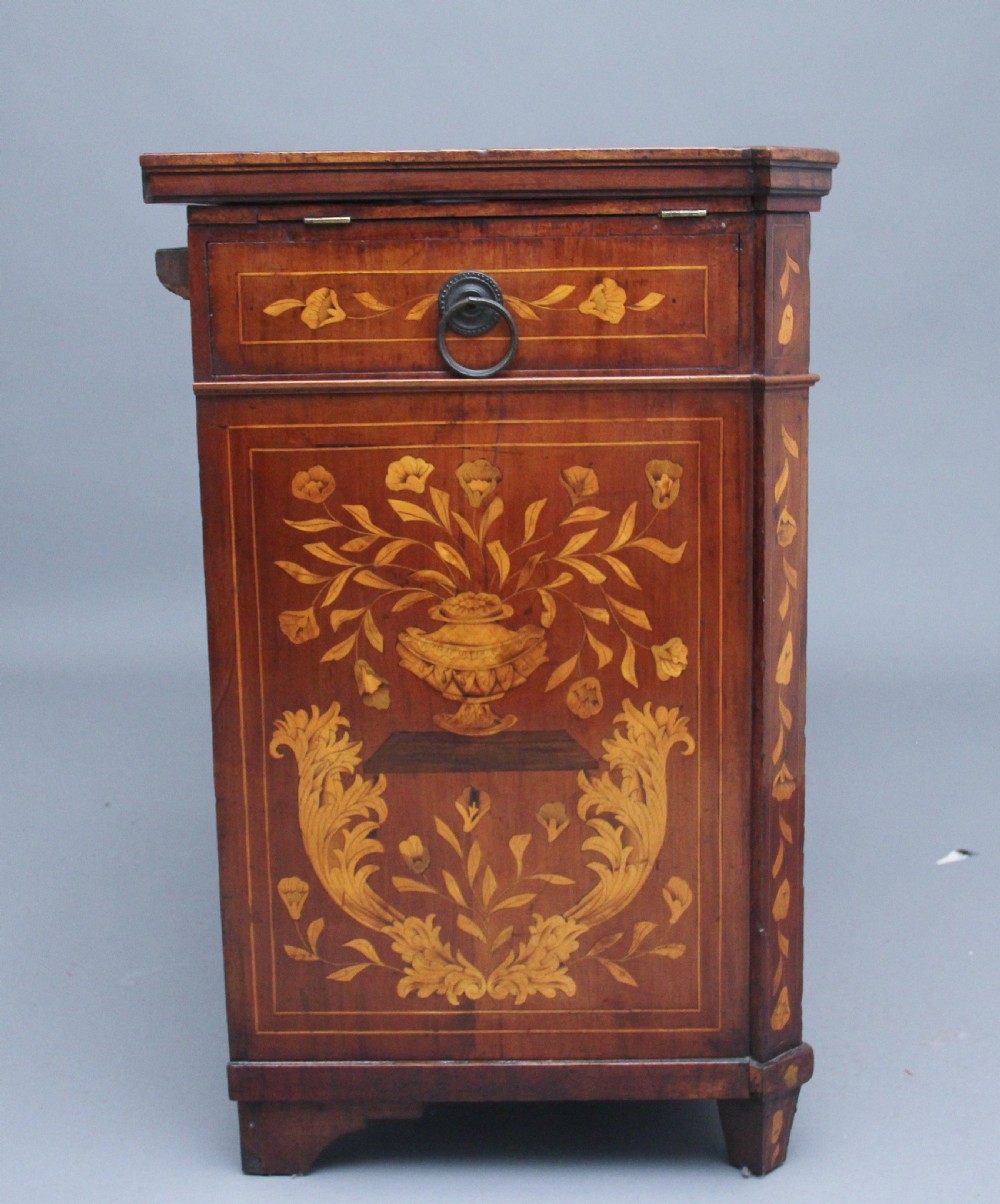 An early 19th-century Dutch travelling cabinet featuring floral fruitwood marquetry inlays, two upper drawers, two panelled doors, and side drop handles. View VII