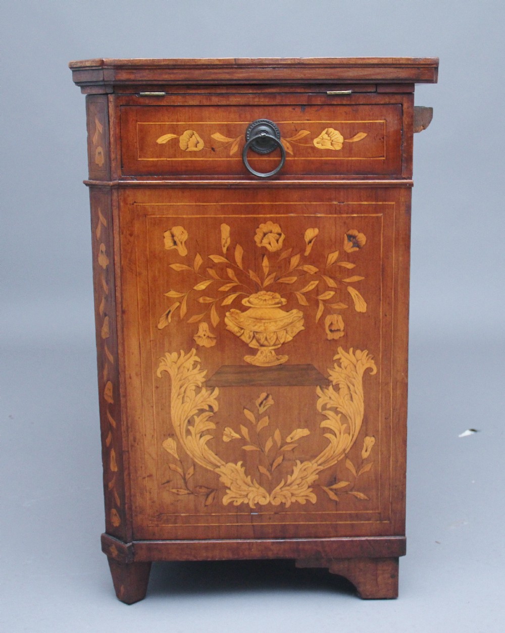 An early 19th-century Dutch travelling cabinet featuring floral fruitwood marquetry inlays, two upper drawers, two panelled doors, and side drop handles. View IX