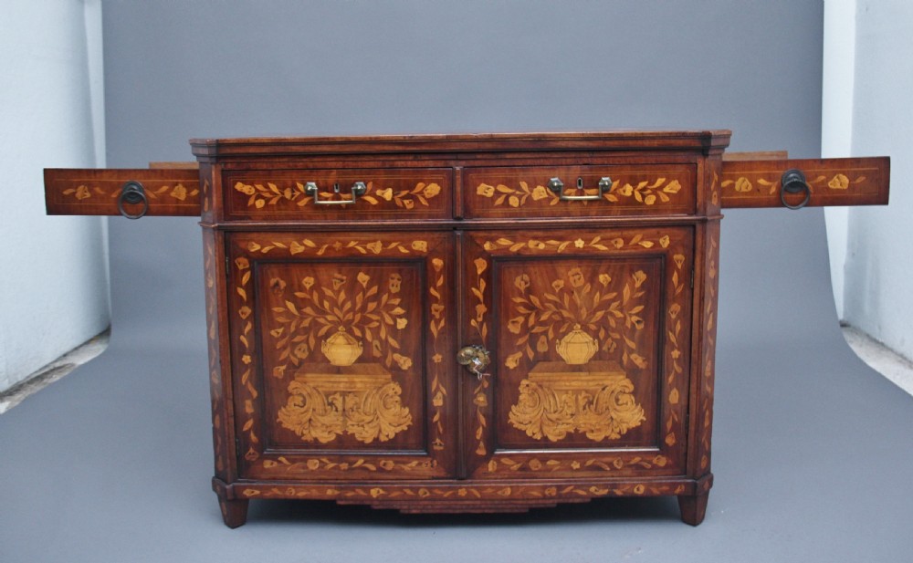An early 19th-century Dutch travelling cabinet featuring floral fruitwood marquetry inlays, two upper drawers, two panelled doors, and side drop handles. View XII