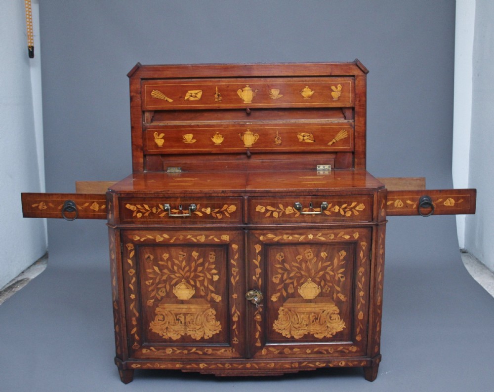 An early 19th-century Dutch travelling cabinet featuring floral fruitwood marquetry inlays, two upper drawers, two panelled doors, and side drop handles. View XIII