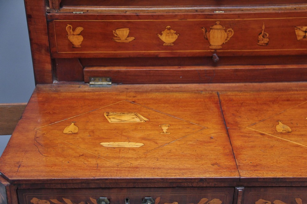 An early 19th-century Dutch travelling cabinet featuring floral fruitwood marquetry inlays, two upper drawers, two panelled doors, and side drop handles. View XV