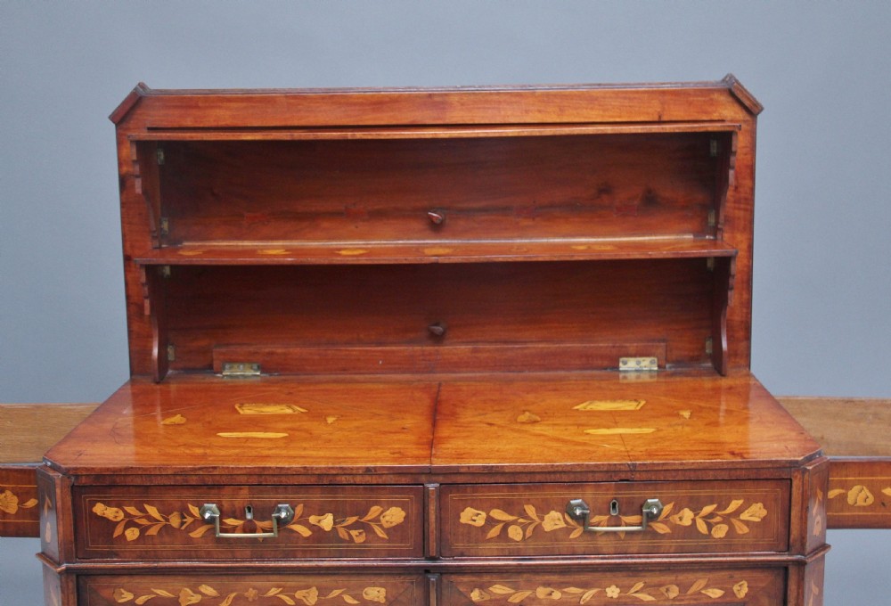 An early 19th-century Dutch travelling cabinet featuring floral fruitwood marquetry inlays, two upper drawers, two panelled doors, and side drop handles. View XVI