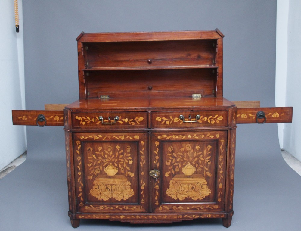 An early 19th-century Dutch travelling cabinet featuring floral fruitwood marquetry inlays, two upper drawers, two panelled doors, and side drop handles. View XVII
