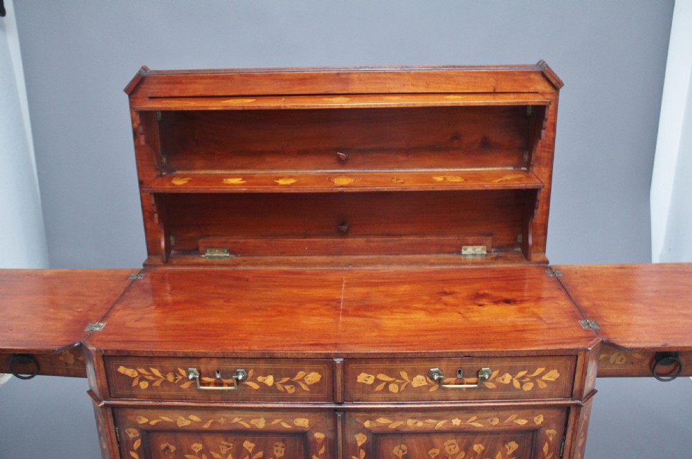 An early 19th-century Dutch travelling cabinet featuring floral fruitwood marquetry inlays, two upper drawers, two panelled doors, and side drop handles. View XVIII