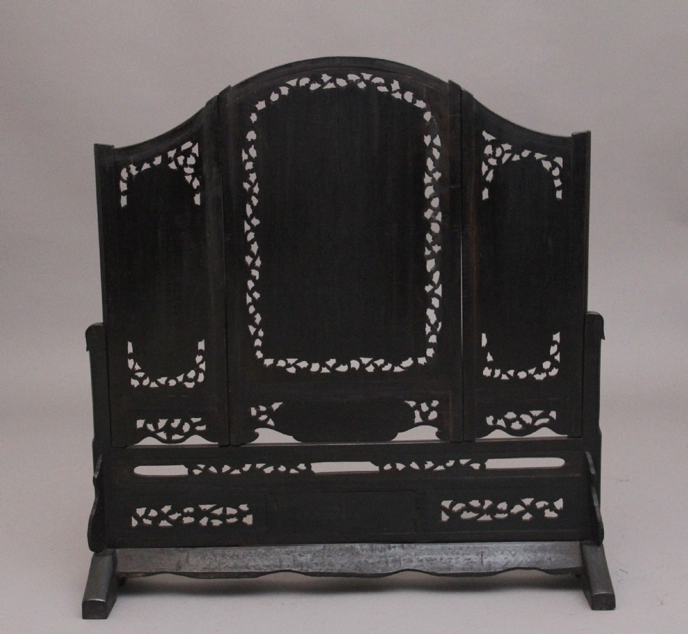 A 19th-century Chinese dark hardwood triptych table screen set with carved openwork borders and detailed mother-of-pearl landscape inlays. View III