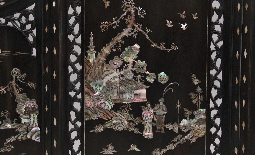 A 19th-century Chinese dark hardwood triptych table screen set with carved openwork borders and detailed mother-of-pearl landscape inlays. View VII