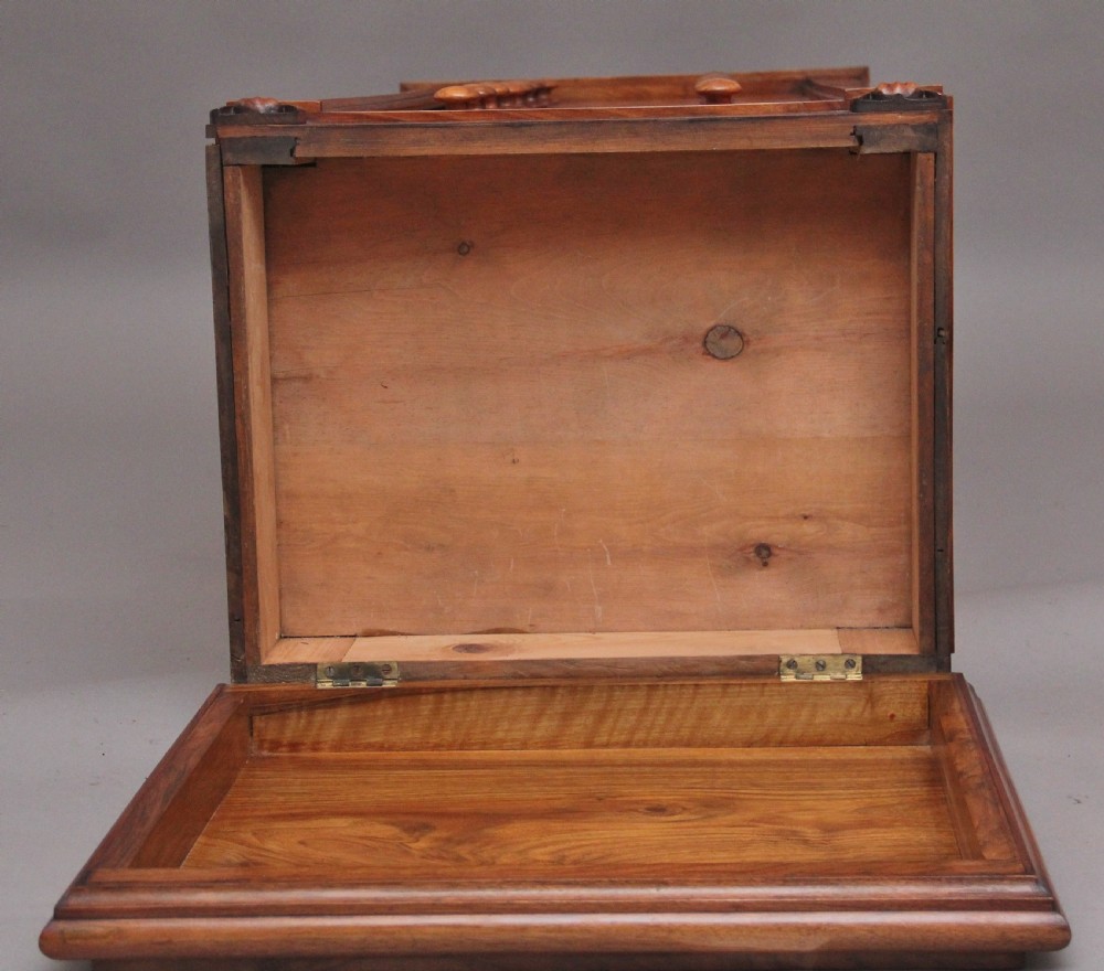 An early nineteenth-century Regency walnut Wellington chest featuring seven drawers with wooden knob handles and carved corbels at the top corners. View XV