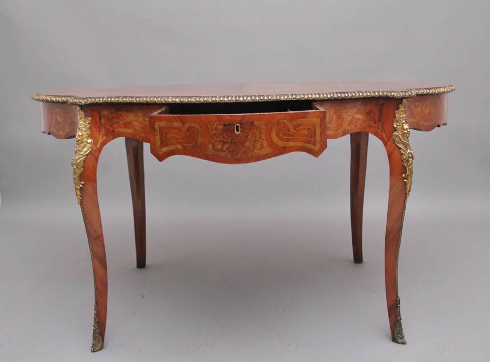 A 19th-century French Rococo style walnut centre table featuring cabriole legs, floral marquetry inlay, and gilded ormolu mounts. View II