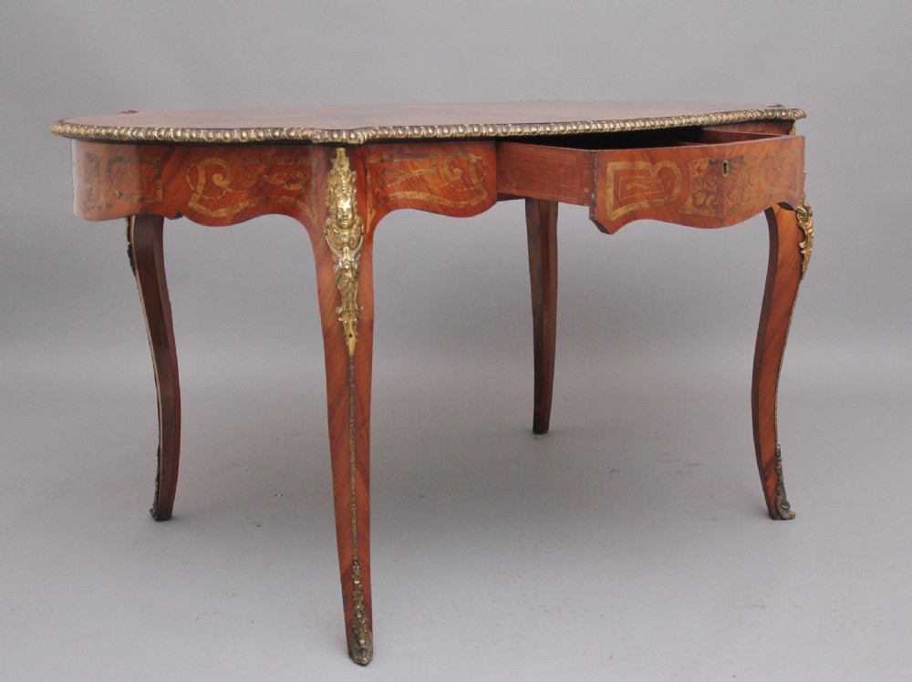 A 19th-century French Rococo style walnut centre table featuring cabriole legs, floral marquetry inlay, and gilded ormolu mounts. View III