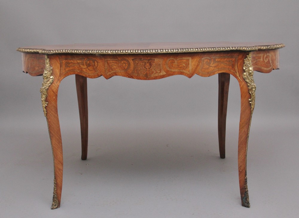 A 19th-century French Rococo style walnut centre table featuring cabriole legs, floral marquetry inlay, and gilded ormolu mounts. View VI