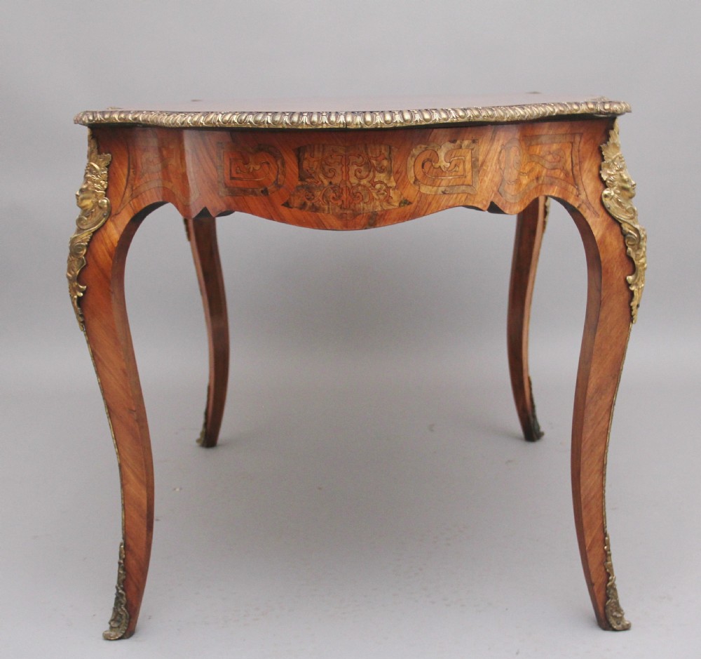 A 19th-century French Rococo style walnut centre table featuring cabriole legs, floral marquetry inlay, and gilded ormolu mounts. View VII