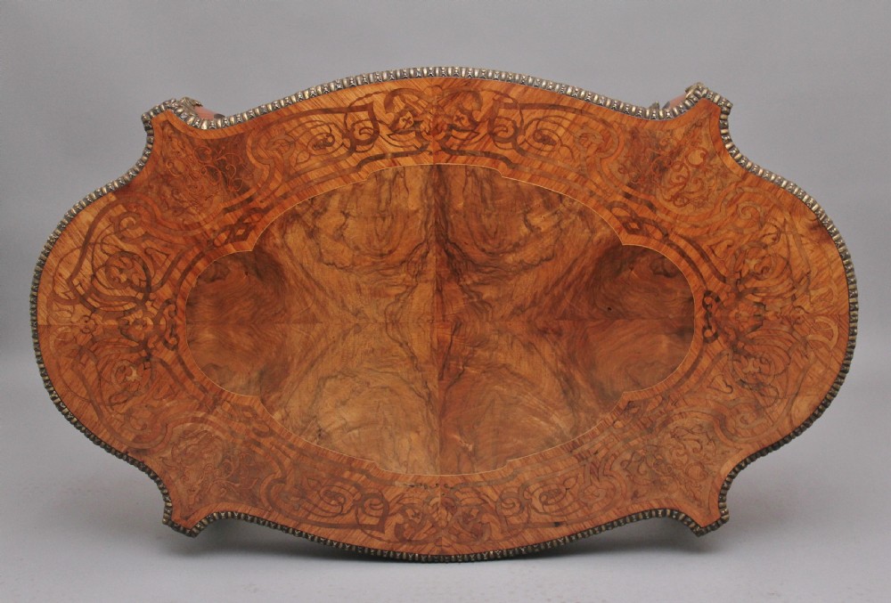 A 19th-century French Rococo style walnut centre table featuring cabriole legs, floral marquetry inlay, and gilded ormolu mounts. View VIII
