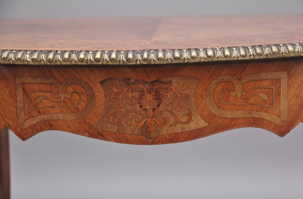 A 19th-century French Rococo style walnut centre table featuring cabriole legs, floral marquetry inlay, and gilded ormolu mounts. View XII