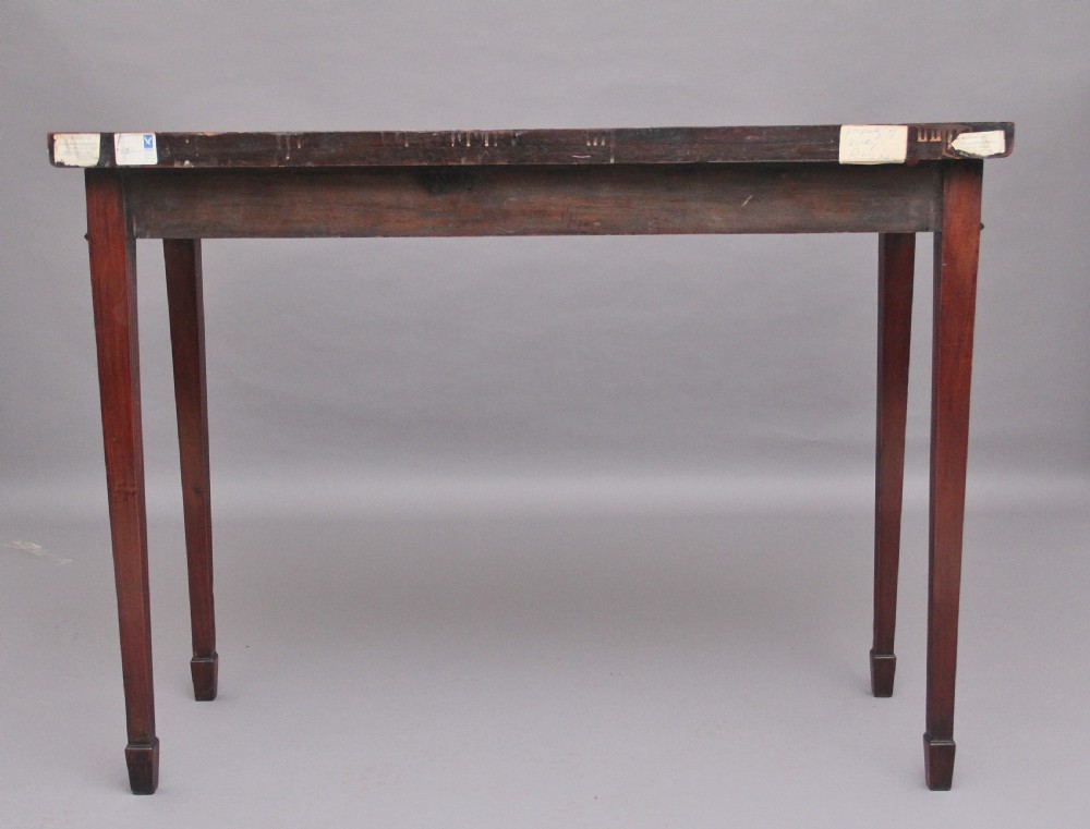 A dark mahogany serpentine console table with fluted legs and carved urn and garland motifs along the apron. View III