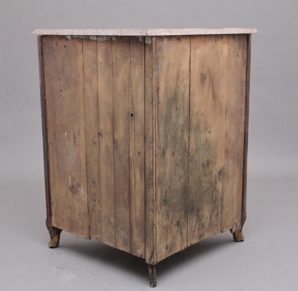 An 18th-century French corner cabinet featuring a curved front with intricate floral marquetry inlay, gilt bronze mounts, and a contoured marble top. View V
