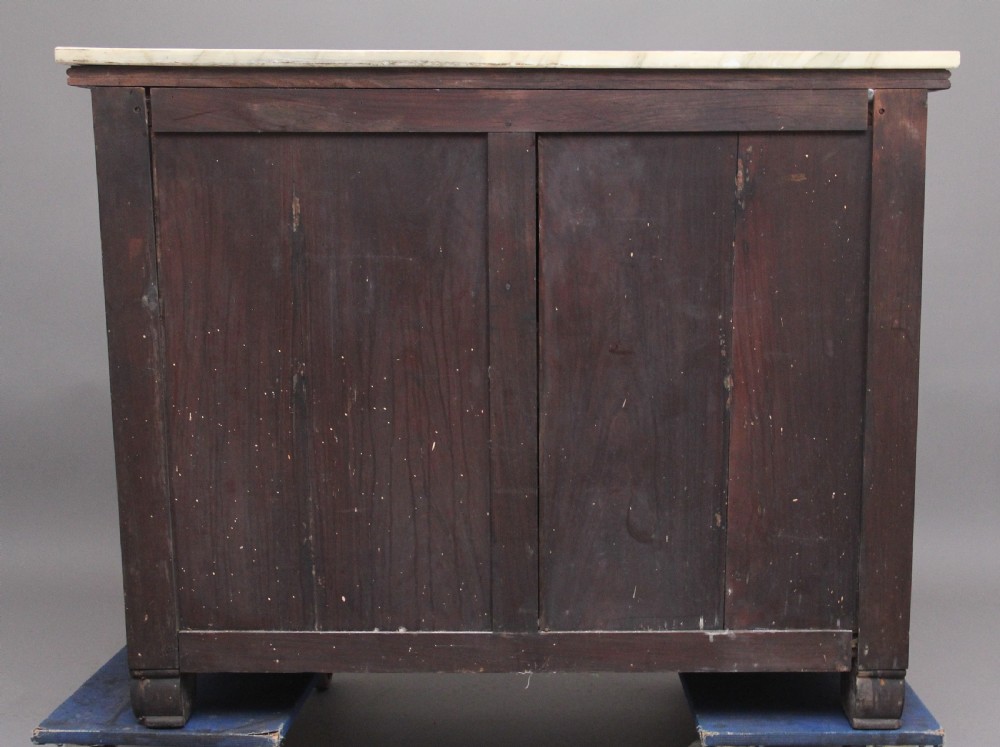 A 19th-century Anglo-Indian dark wood cabinet featuring a white marble top, two carved drawers, and two doors decorated with intricate pierced floral relief motifs. View VIII