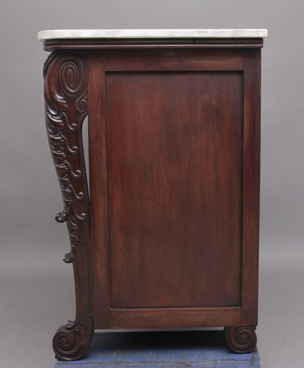 A 19th-century Anglo-Indian dark wood cabinet featuring a white marble top, two carved drawers, and two doors decorated with intricate pierced floral relief motifs. View IX