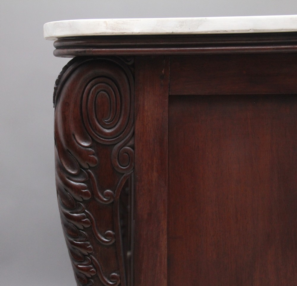 A 19th-century Anglo-Indian dark wood cabinet featuring a white marble top, two carved drawers, and two doors decorated with intricate pierced floral relief motifs. View XI