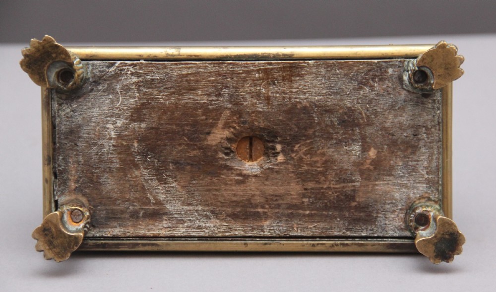 A 19th-century mahogany desk set featuring two metal inkwells, a central column topped with a small gilt figure, and four detailed claw feet. View IX