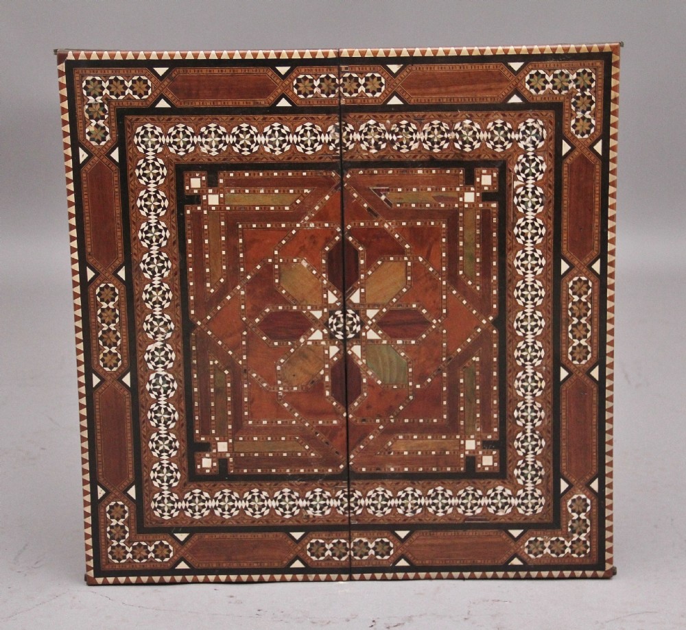 A 19th-century Syrian metamorphic writing table with geometric mother-of-pearl inlay, side flap leaves, and a green writing surface. View V