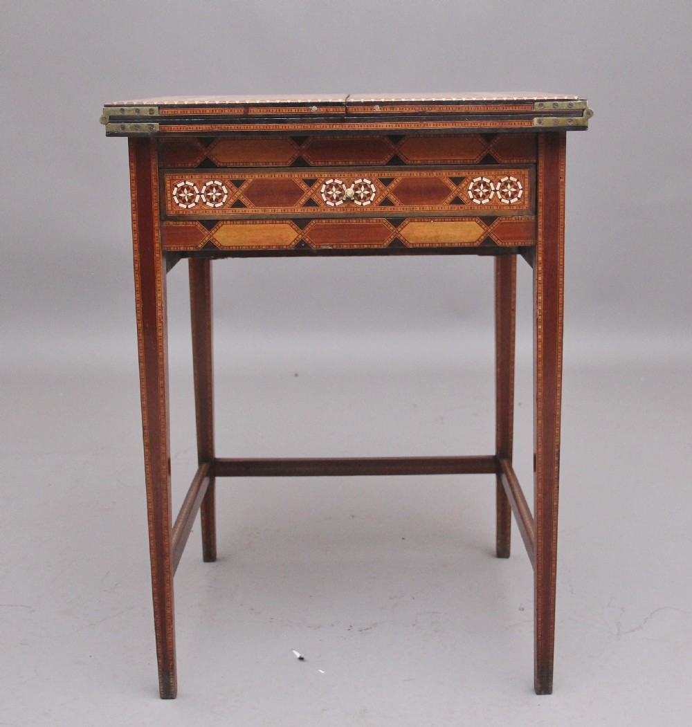 A 19th-century Syrian metamorphic writing table with geometric mother-of-pearl inlay, side flap leaves, and a green writing surface. View VI