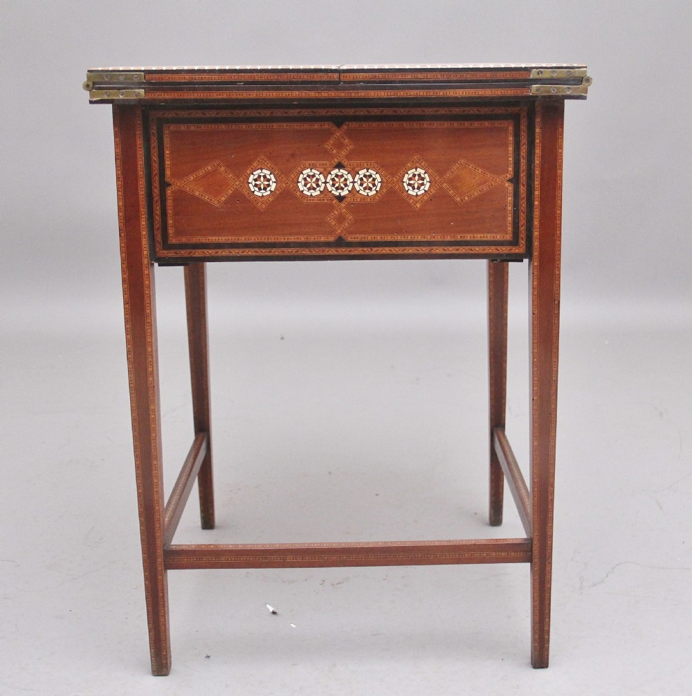 A 19th-century Syrian metamorphic writing table with geometric mother-of-pearl inlay, side flap leaves, and a green writing surface. View IX