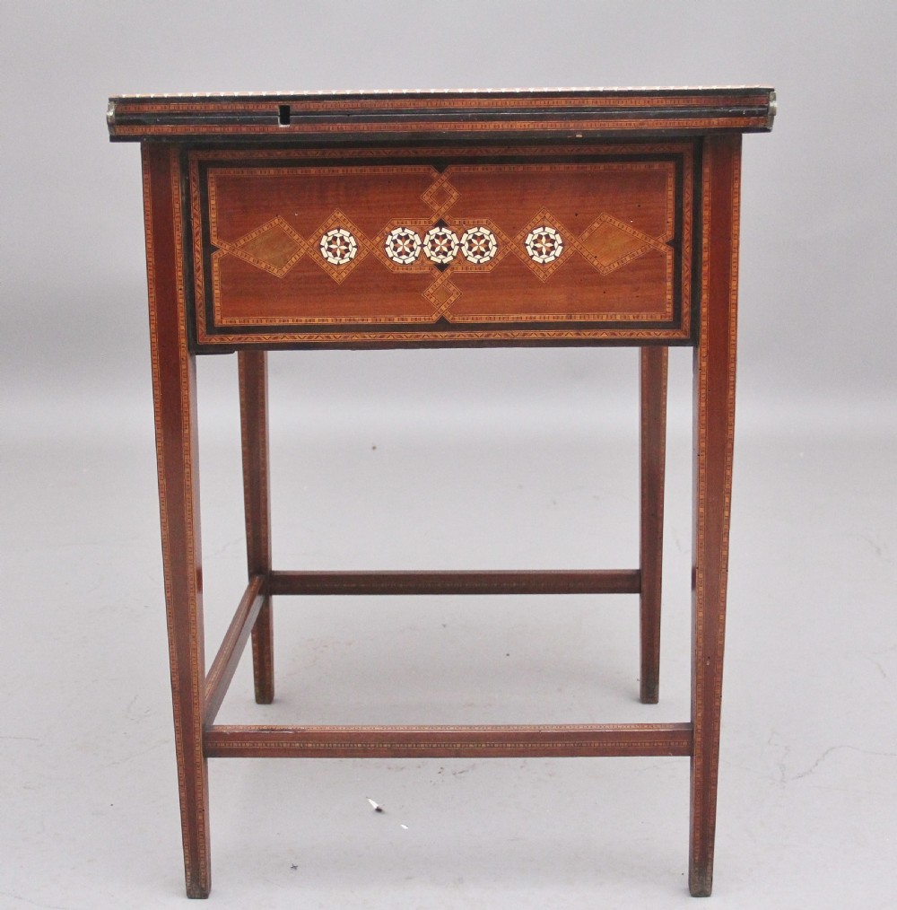 A 19th-century Syrian metamorphic writing table with geometric mother-of-pearl inlay, side flap leaves, and a green writing surface. View X