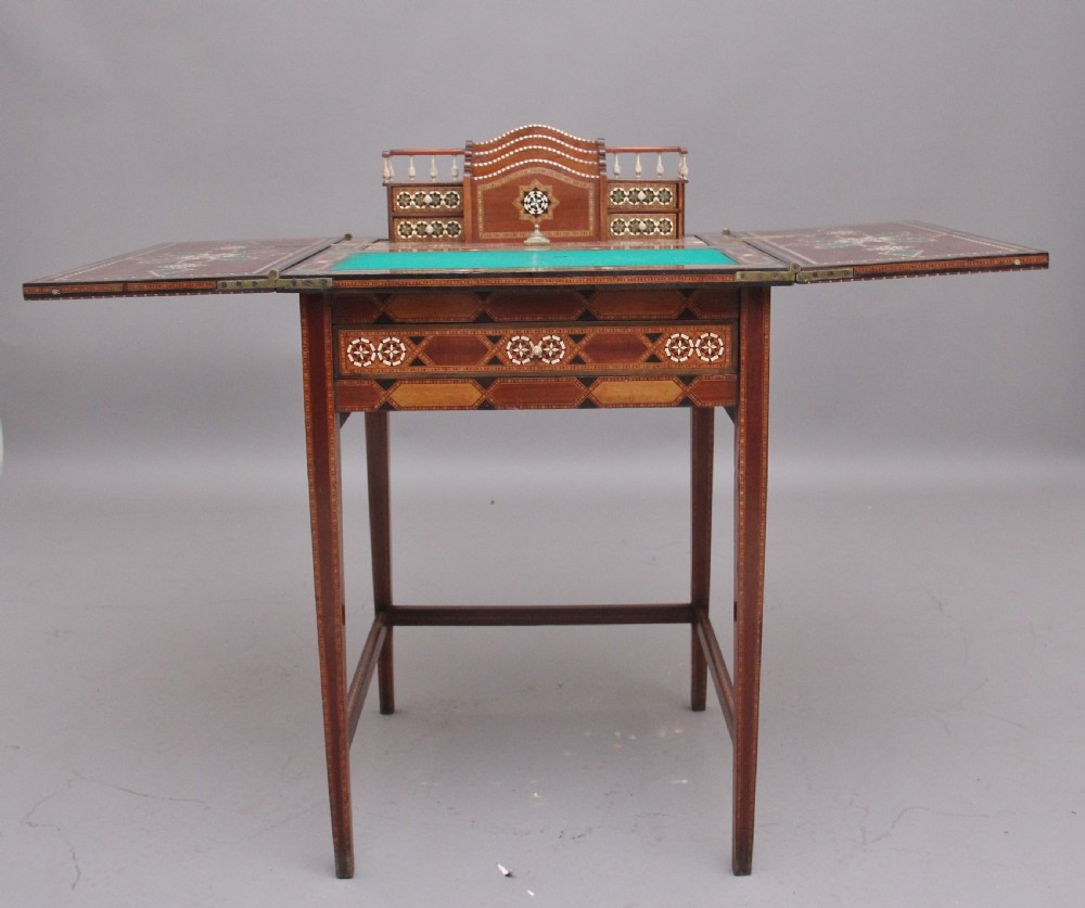 A 19th-century Syrian metamorphic writing table with geometric mother-of-pearl inlay, side flap leaves, and a green writing surface. View XI