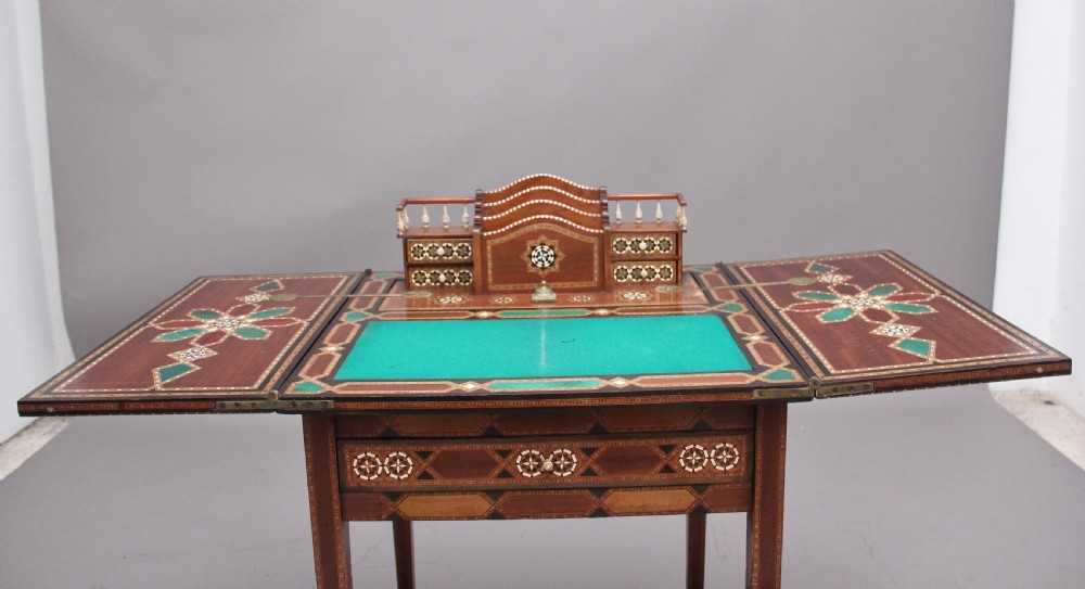 A 19th-century Syrian metamorphic writing table with geometric mother-of-pearl inlay, side flap leaves, and a green writing surface. View XII