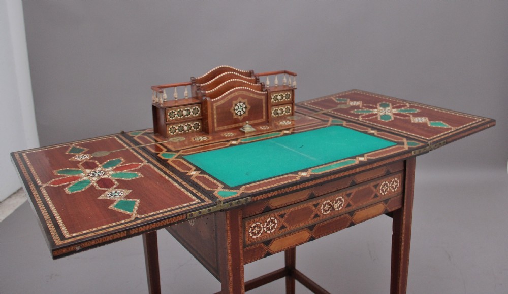 A 19th-century Syrian metamorphic writing table with geometric mother-of-pearl inlay, side flap leaves, and a green writing surface. View XIII